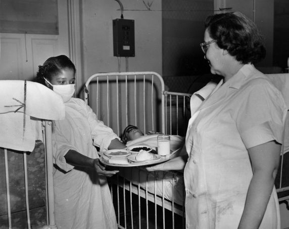 (29166) Female Food Service Employees Tending to Patient, 1952