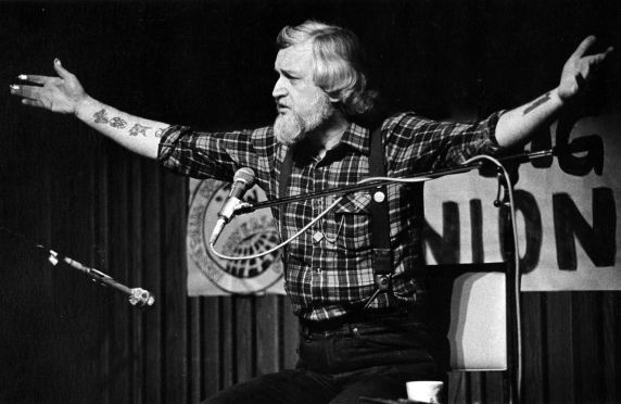 (32374) Utah Phillips Raising His Arms and Speaking During a Performance, Washington, circa 1980