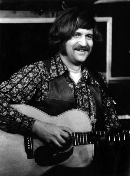 (32389) Utah Phillips Smiling and Playing the Guitar, circa 1970s