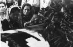 (3810) Maximina de la Cruz stands before her husband's casket, 1973