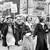 women protect in the streets with picket signs